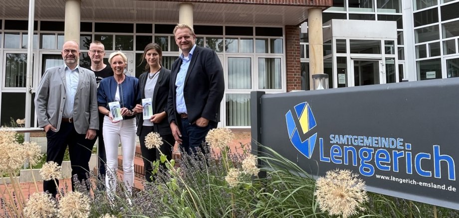 Christoph Schwerdt und Lisa Krieger (genial eG), Samtgemeindebürgermeister Matthias Lühn und Fachbereichsleiter Ansgar Kötting von der Samtgemeinde Lengerich sowie Melanie Schulten vom Landkreis Emsland stehen vor dem Rathaus der Samtgemeinde Lengerich